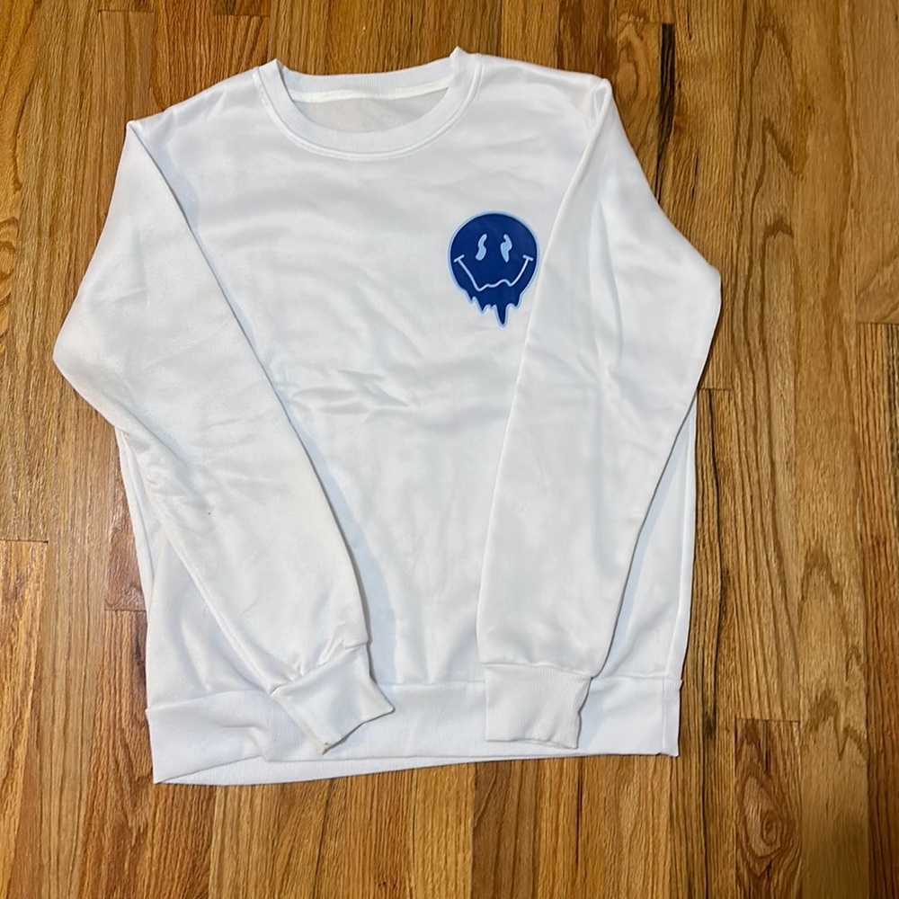 White crew neck with blue smile faces only worn once
